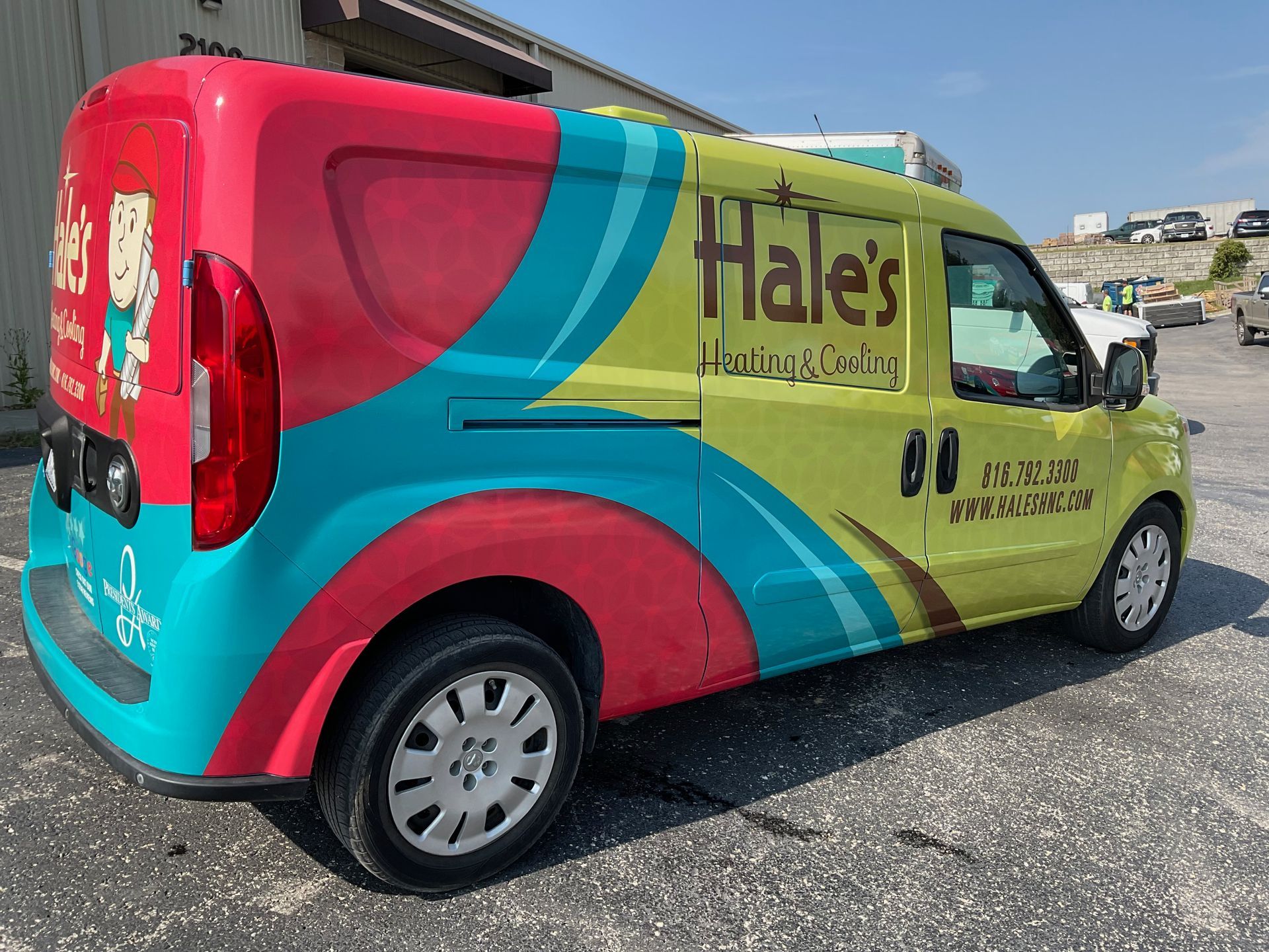 A brightly colored Hale's Heating & Cooling van in red, teal, and lime green parked in a parking lot.