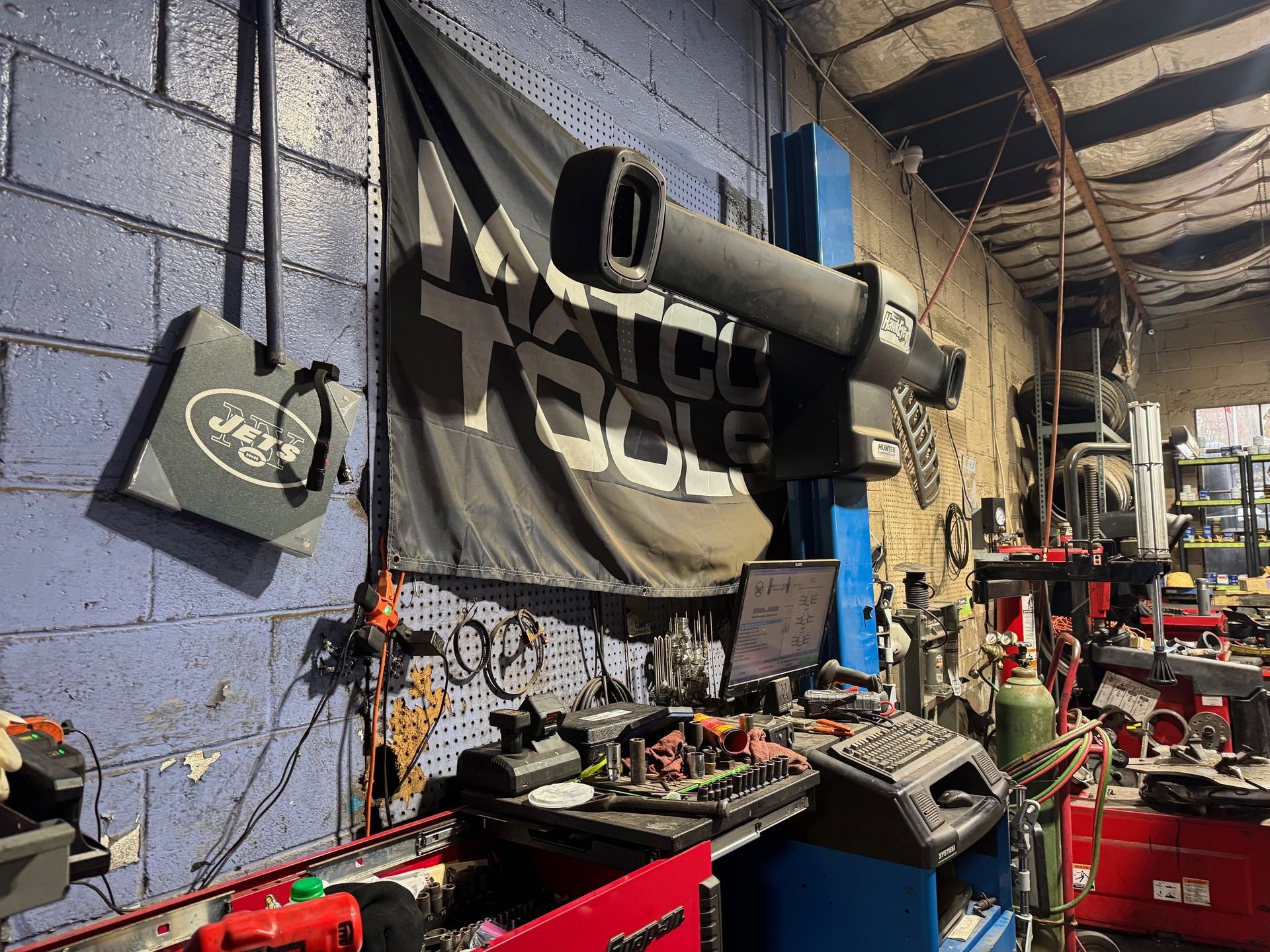Garage interior with tools, a flag, and diagnostic equipment.