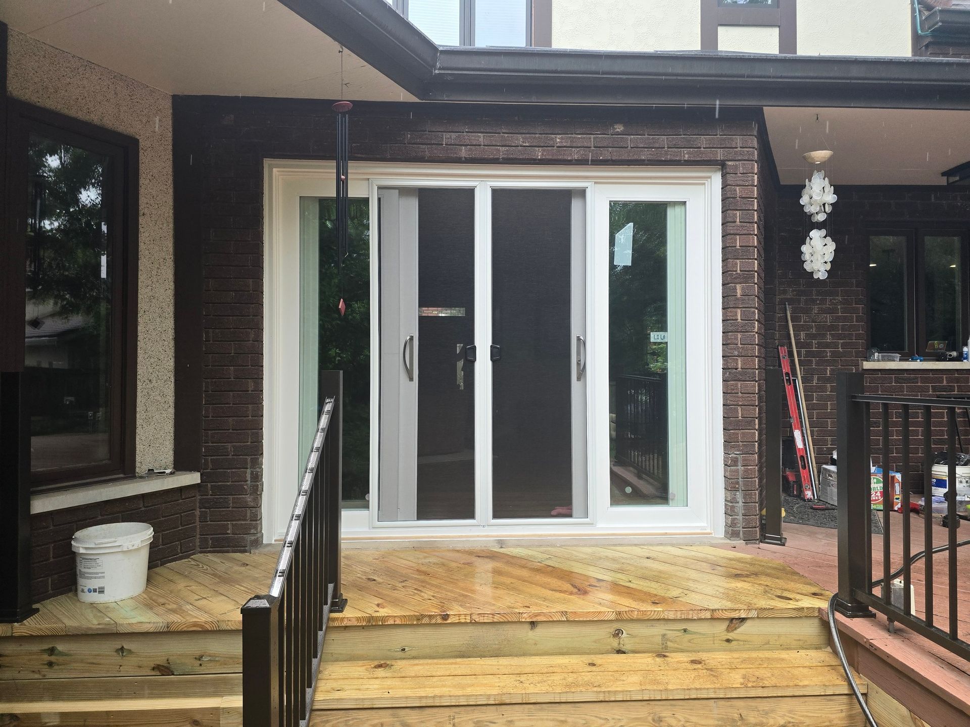 A house with sliding glass doors and a wooden deck.