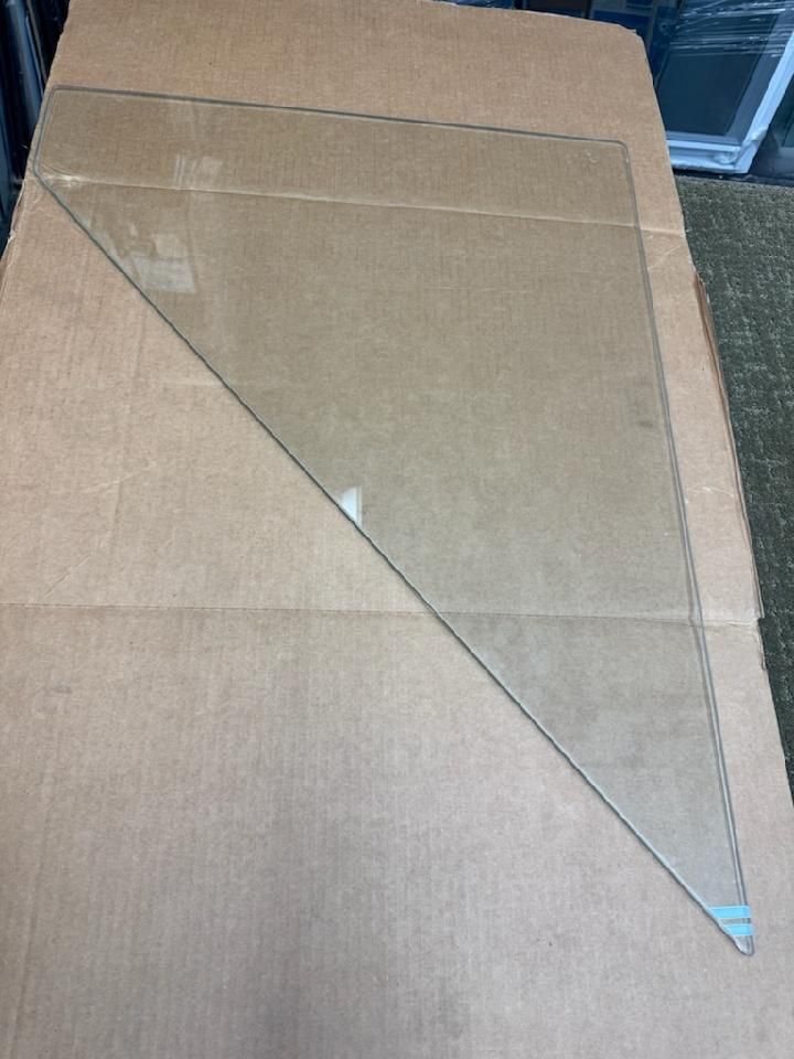 A piece of glass is sitting on top of a cardboard box