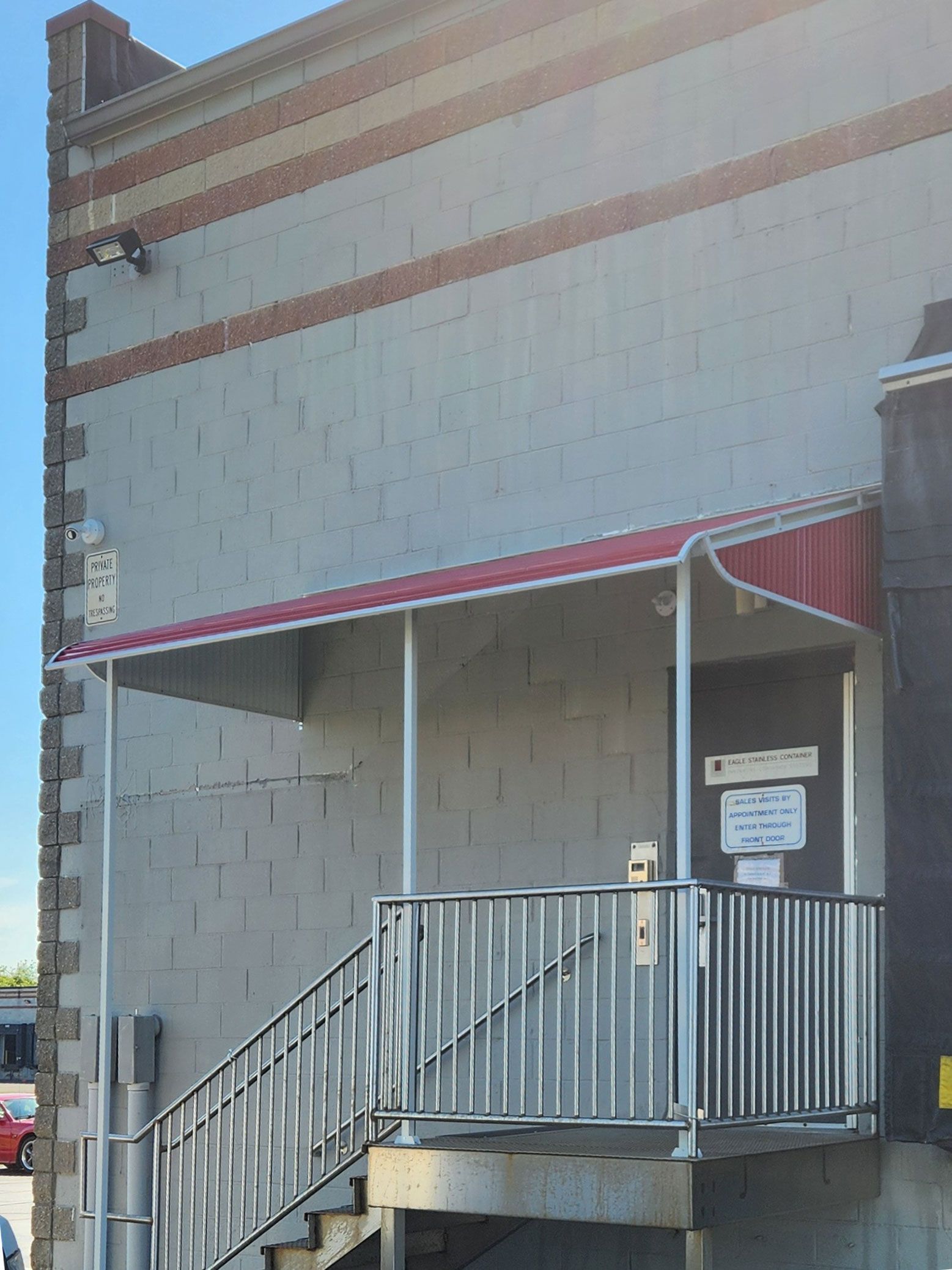 A building with a red awning and stairs leading up to it.