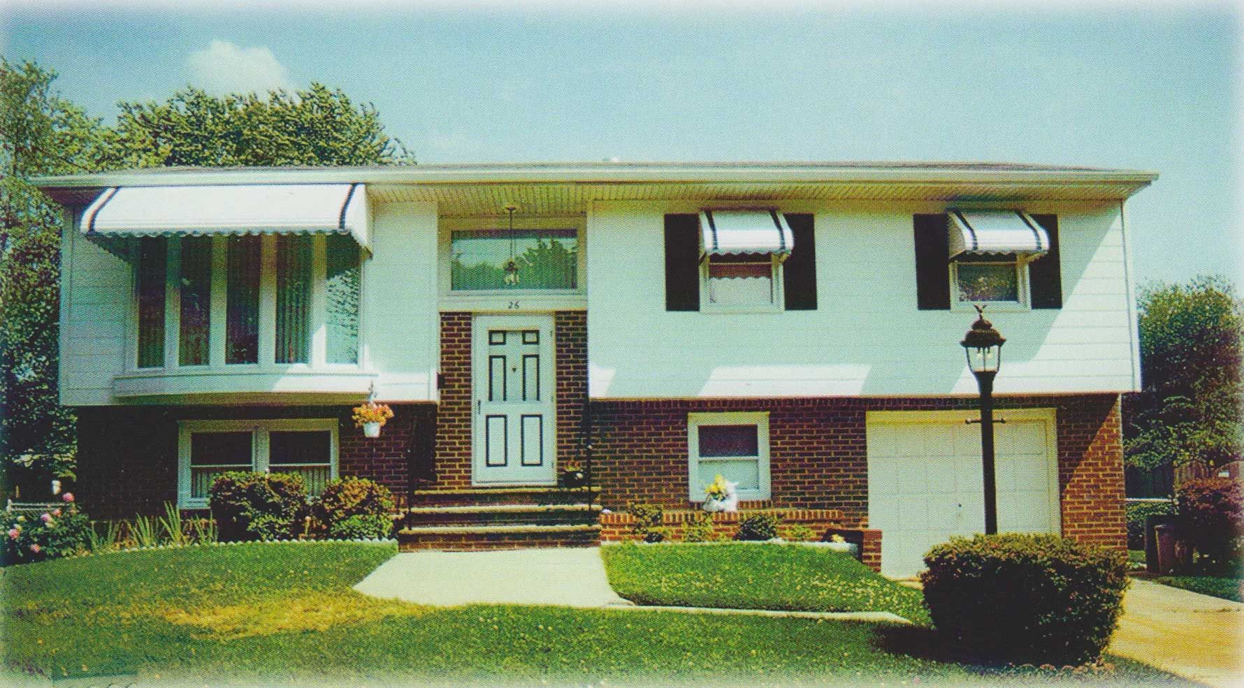A white house with black shutters on the windows