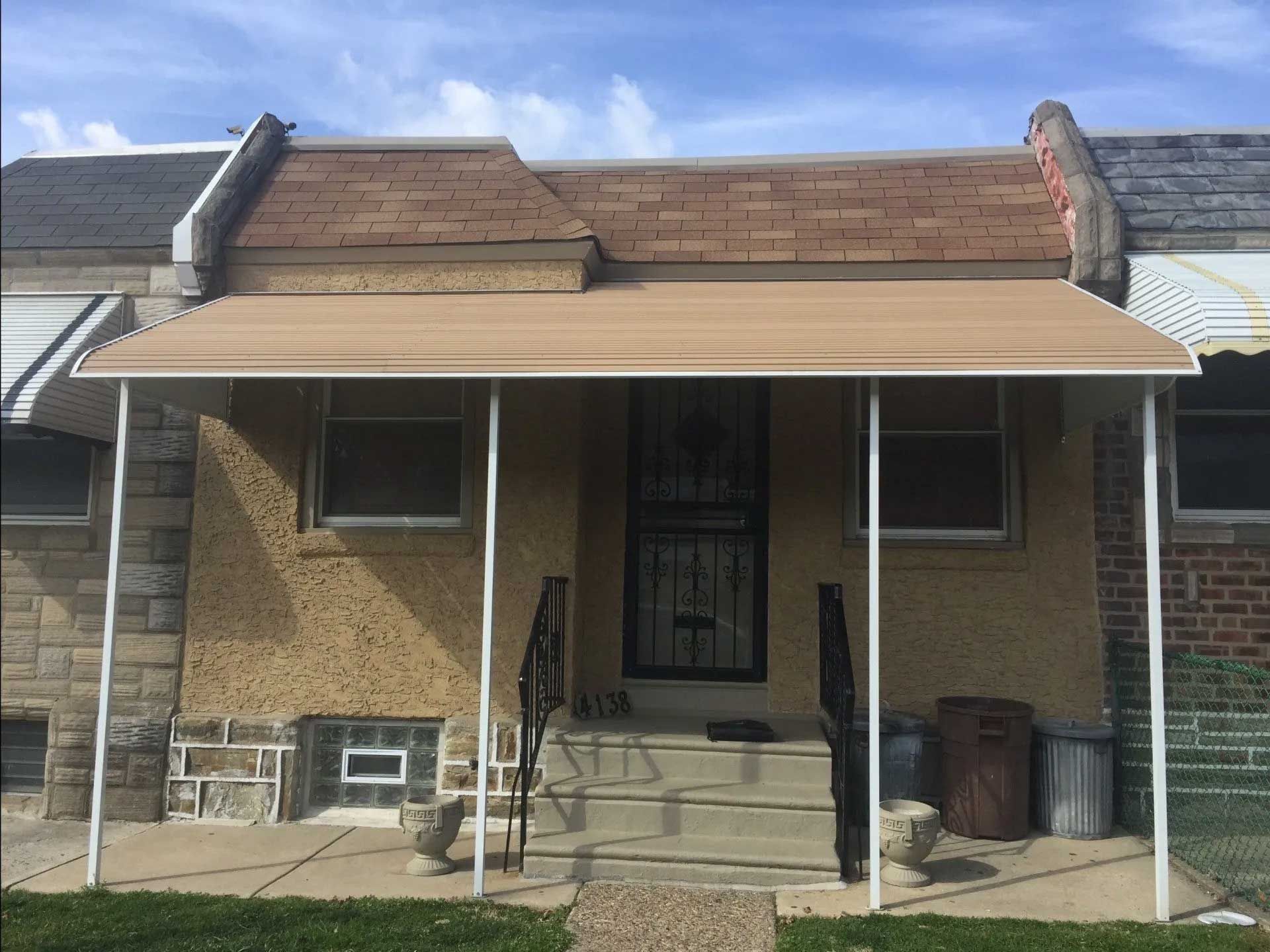 A house with a awning on the front porch