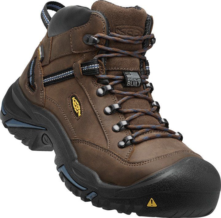 A pair of brown keen hiking boots on a white background