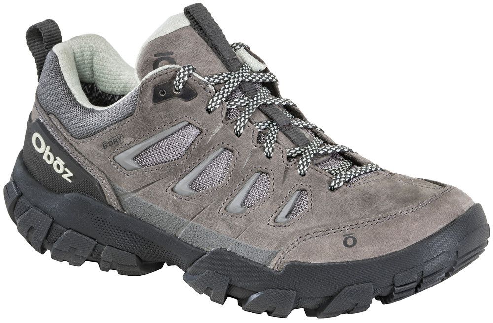 A pair of gray and black oboz shoes on a white background