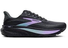 A pair of black and purple running shoes on a white background.