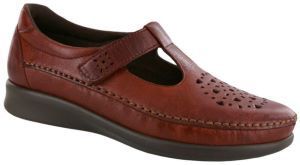 A pair of brown shoes with holes in them on a white background.