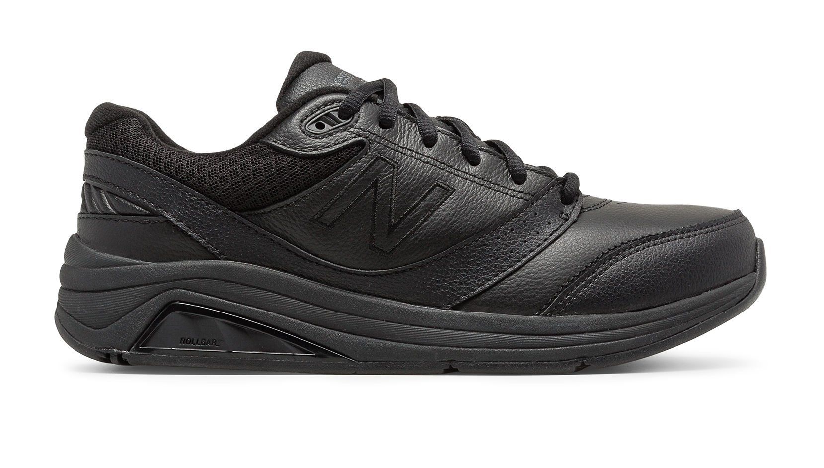 A pair of black new balance shoes on a white background.