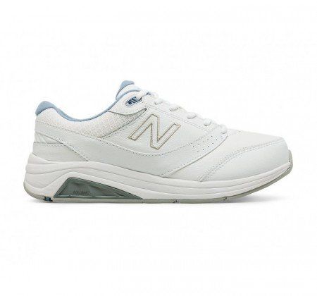 A pair of white new balance walking shoes on a white background.