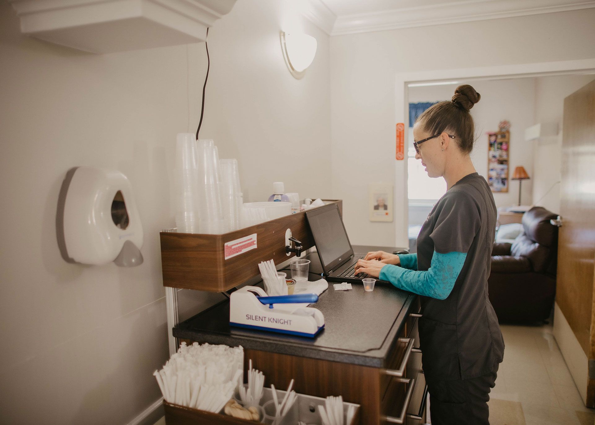 nurse typing on laptop