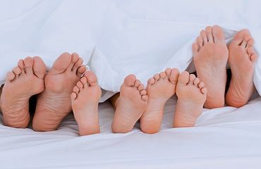 Feet of a family in bed