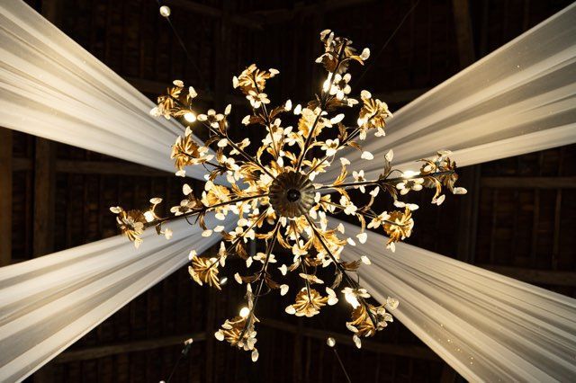 A chandelier is hanging from the ceiling in a dark room