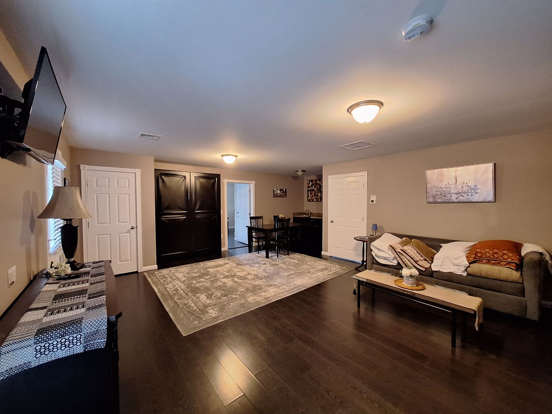 A living room with a couch , table , and television.
