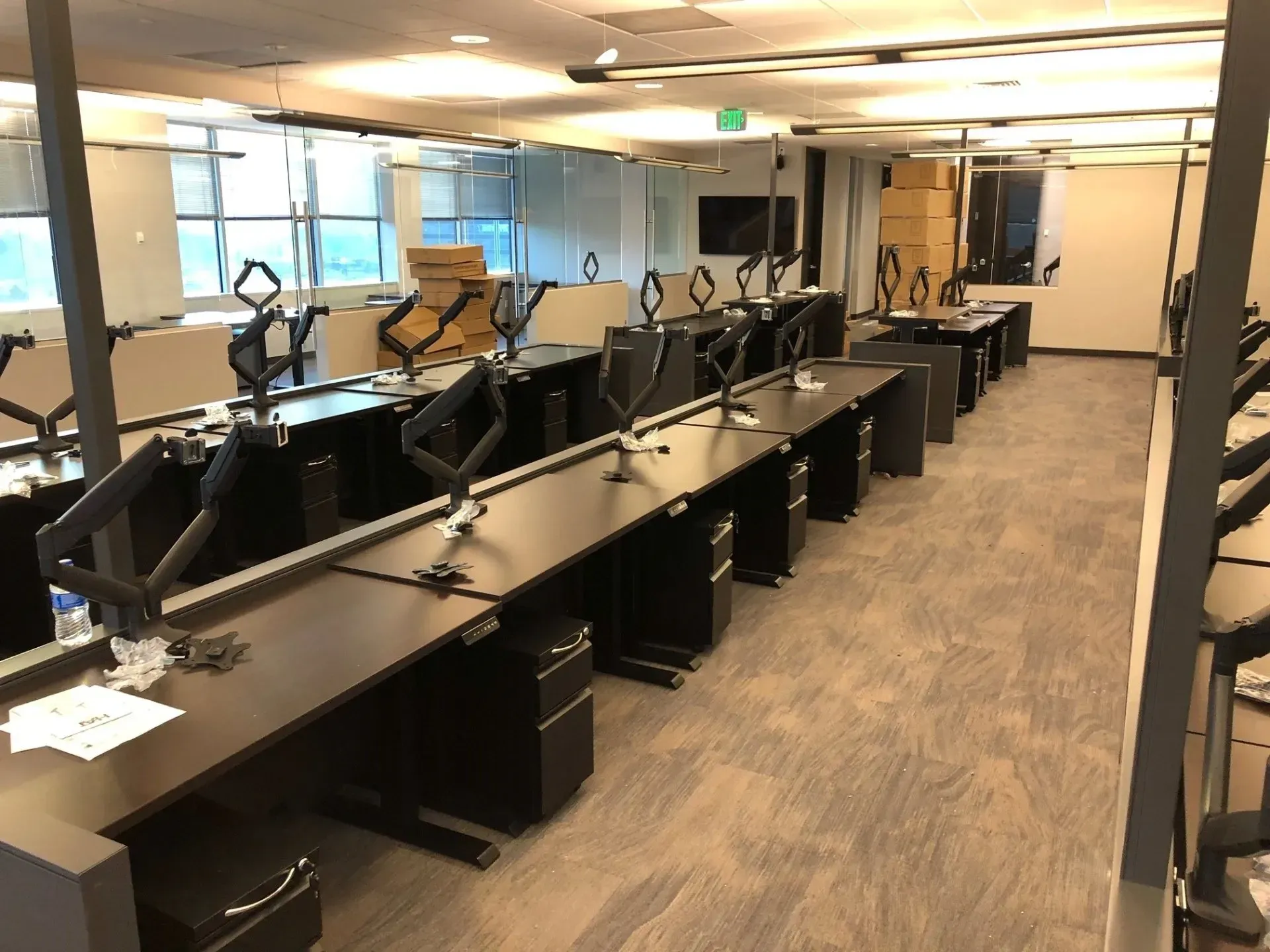 Empty modern office with rows of computer workstations and monitors