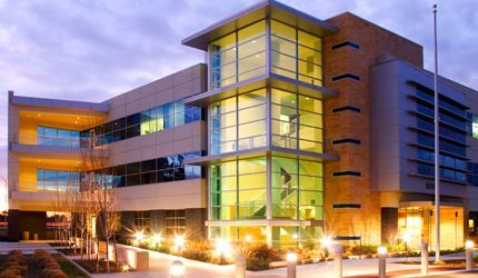 A large building with lots of windows is lit up at night