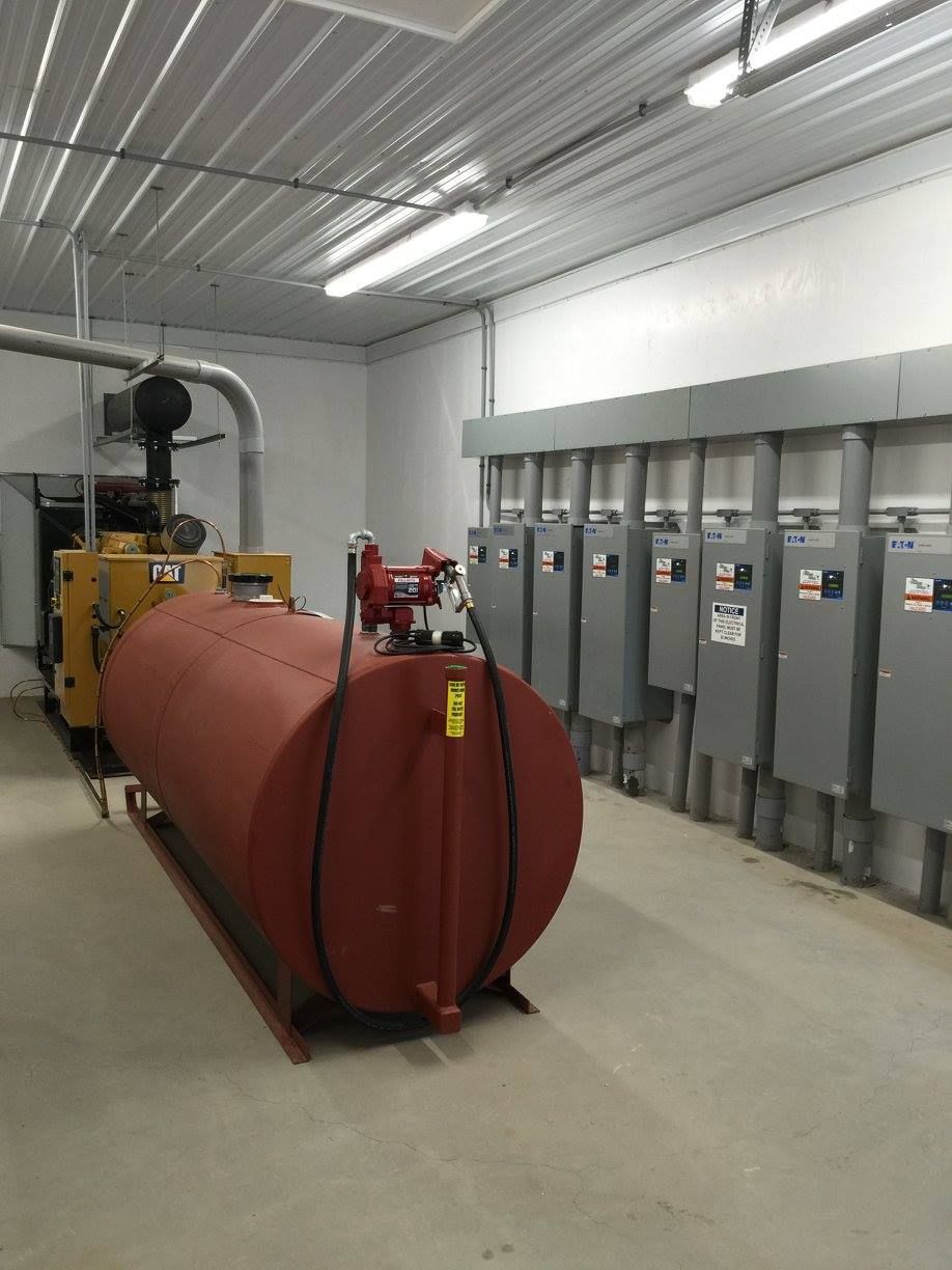A large red tank is sitting in the middle of a room.