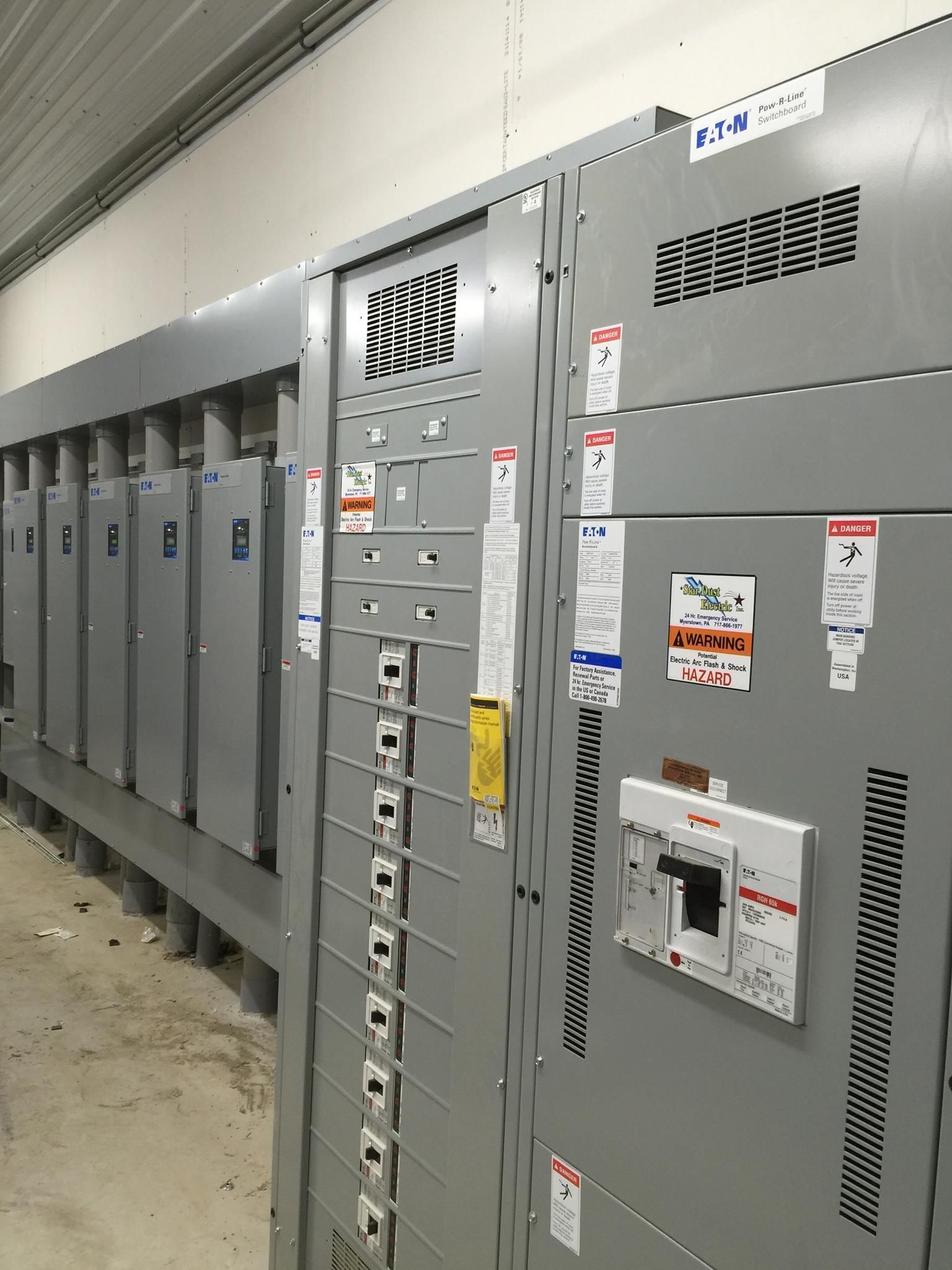 A row of electrical panels with labels on them.