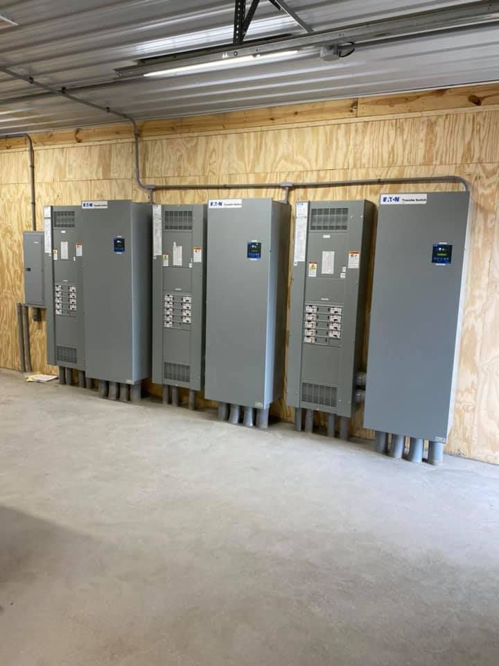 A row of electrical boxes are lined up in a room.