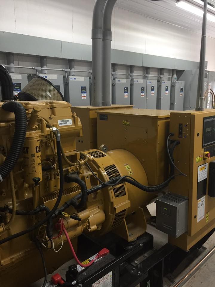 A large yellow generator is sitting in a room.