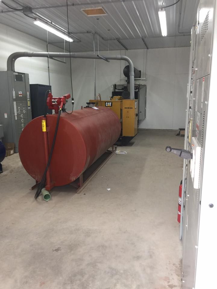A large red tank is sitting in the middle of a room.