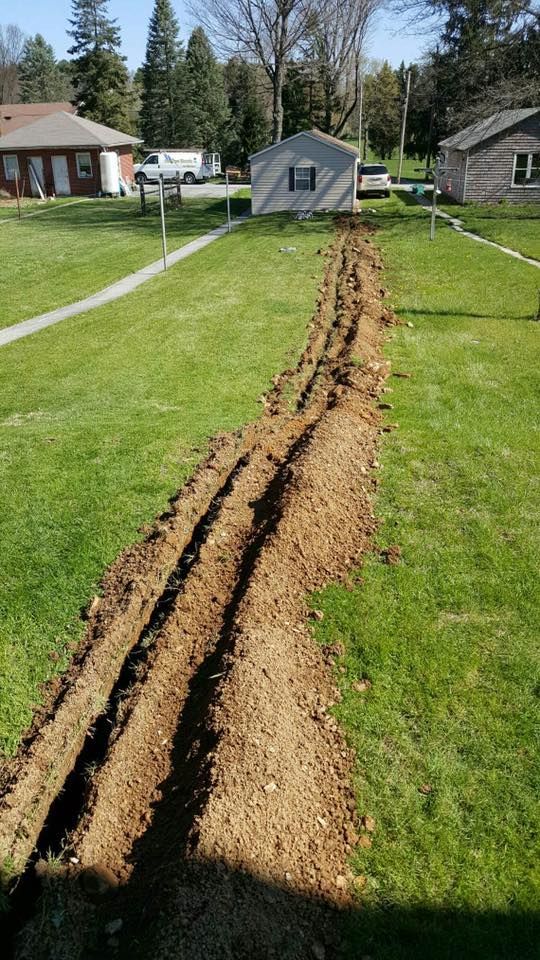 Digging of field for electrical pipes going through house.