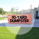 A 10 yard dumpster is parked in front of a house.