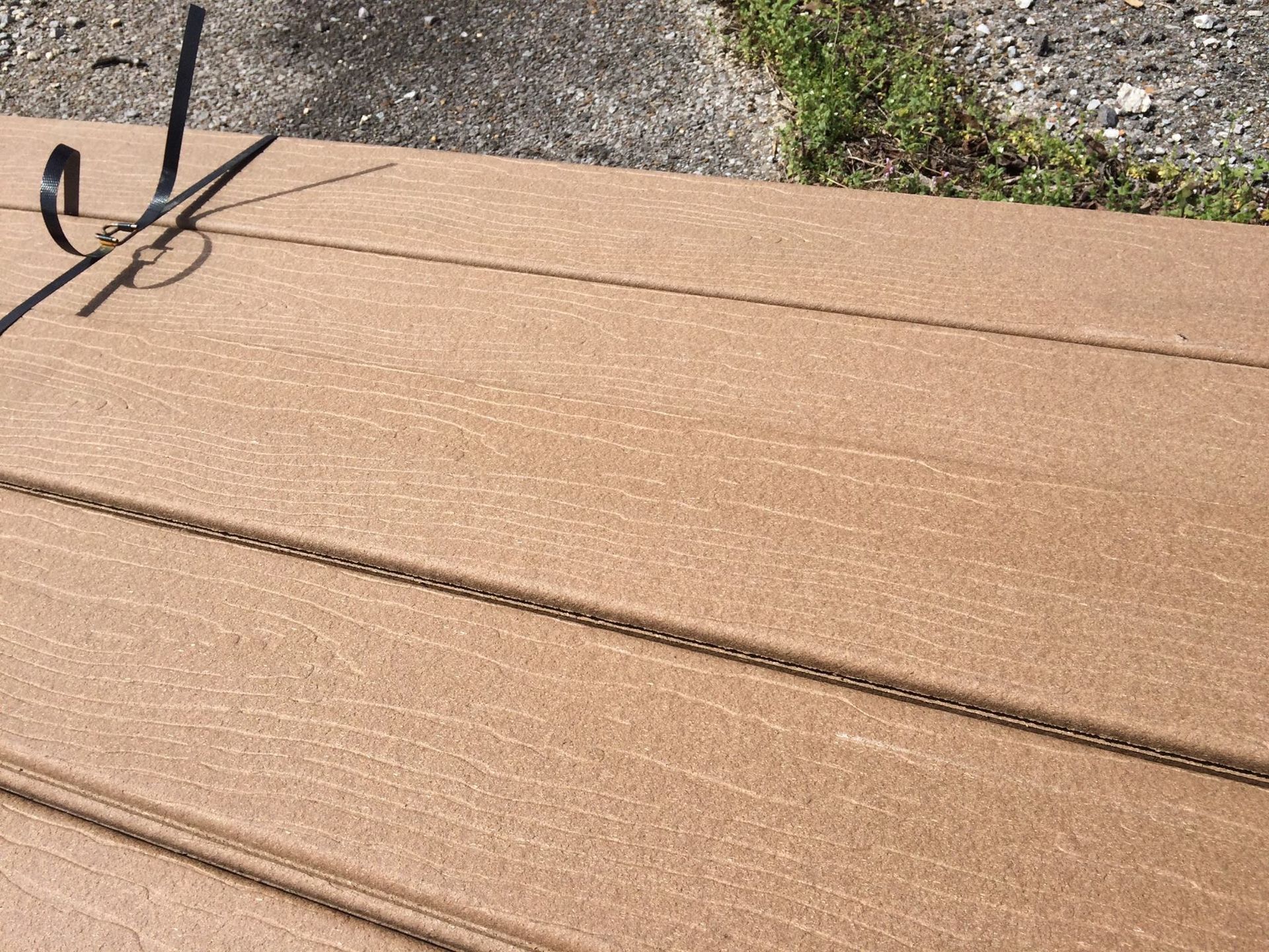 Brown composite deck with metal hook, close-up shot.