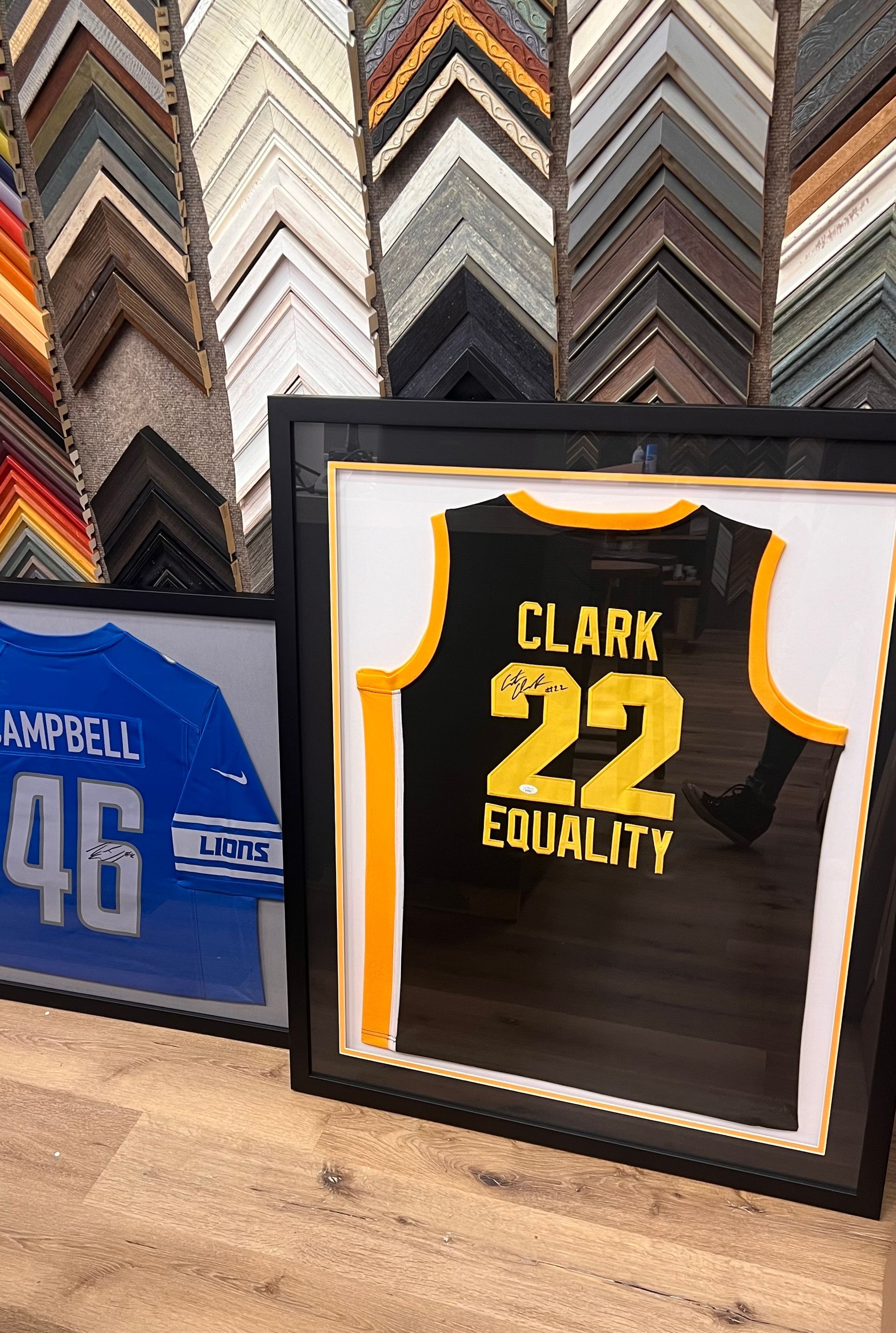 Two framed sports jerseys, one blue 