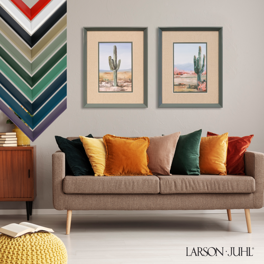Two framed desert cactus prints hang above a brown sofa with multicolored pillows, with a frame color palette on the left.