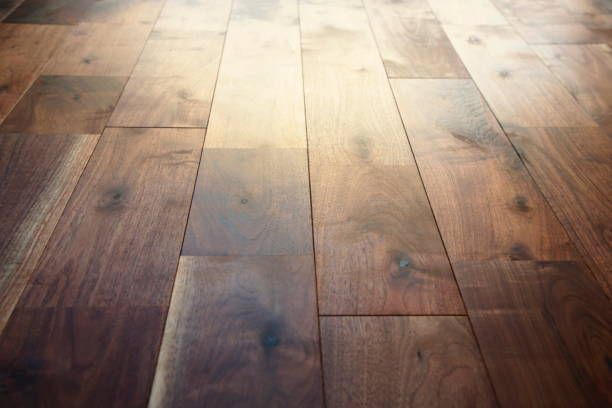 A close up of a wooden floor with the sun shining through it.