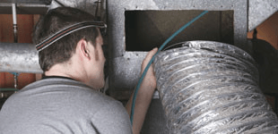 Man repairing a duct