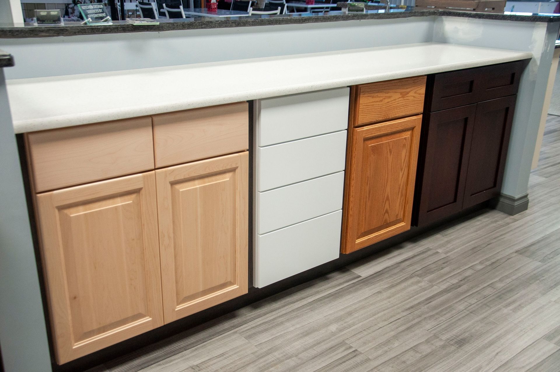 Kitchen cabinet samples in various wood tones.