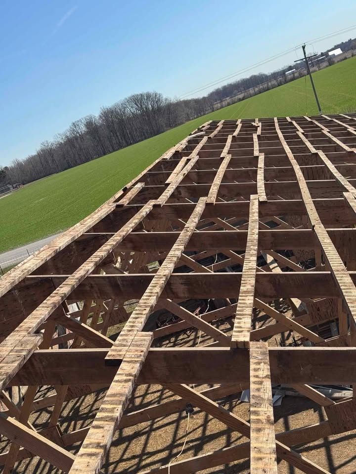 Wooden structure grid on a sunny day with green field and blue sky in the background.