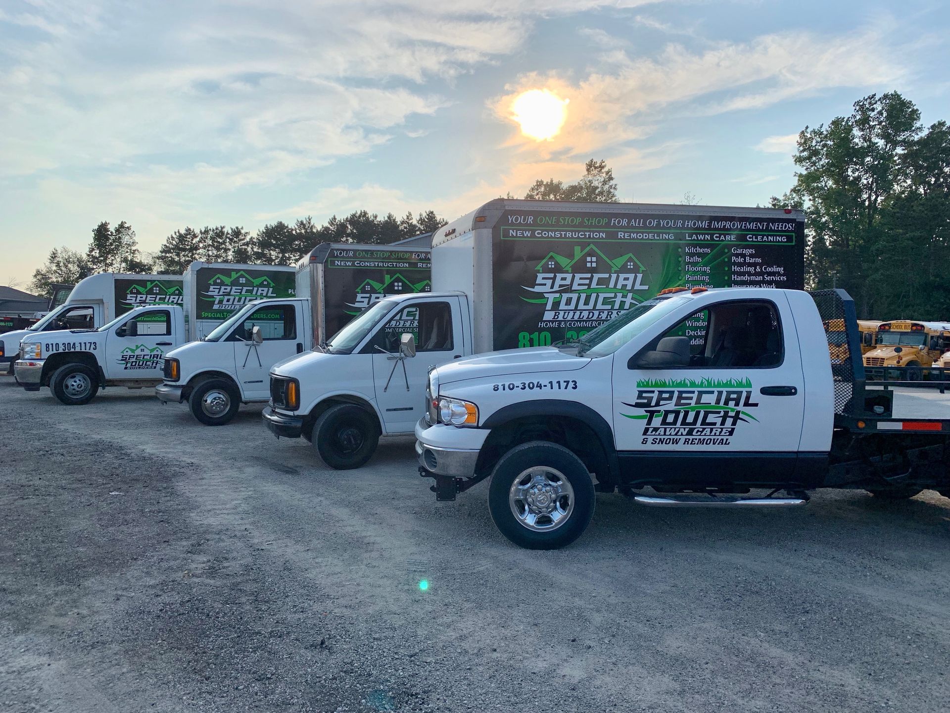 Several white trucks parked, each with 