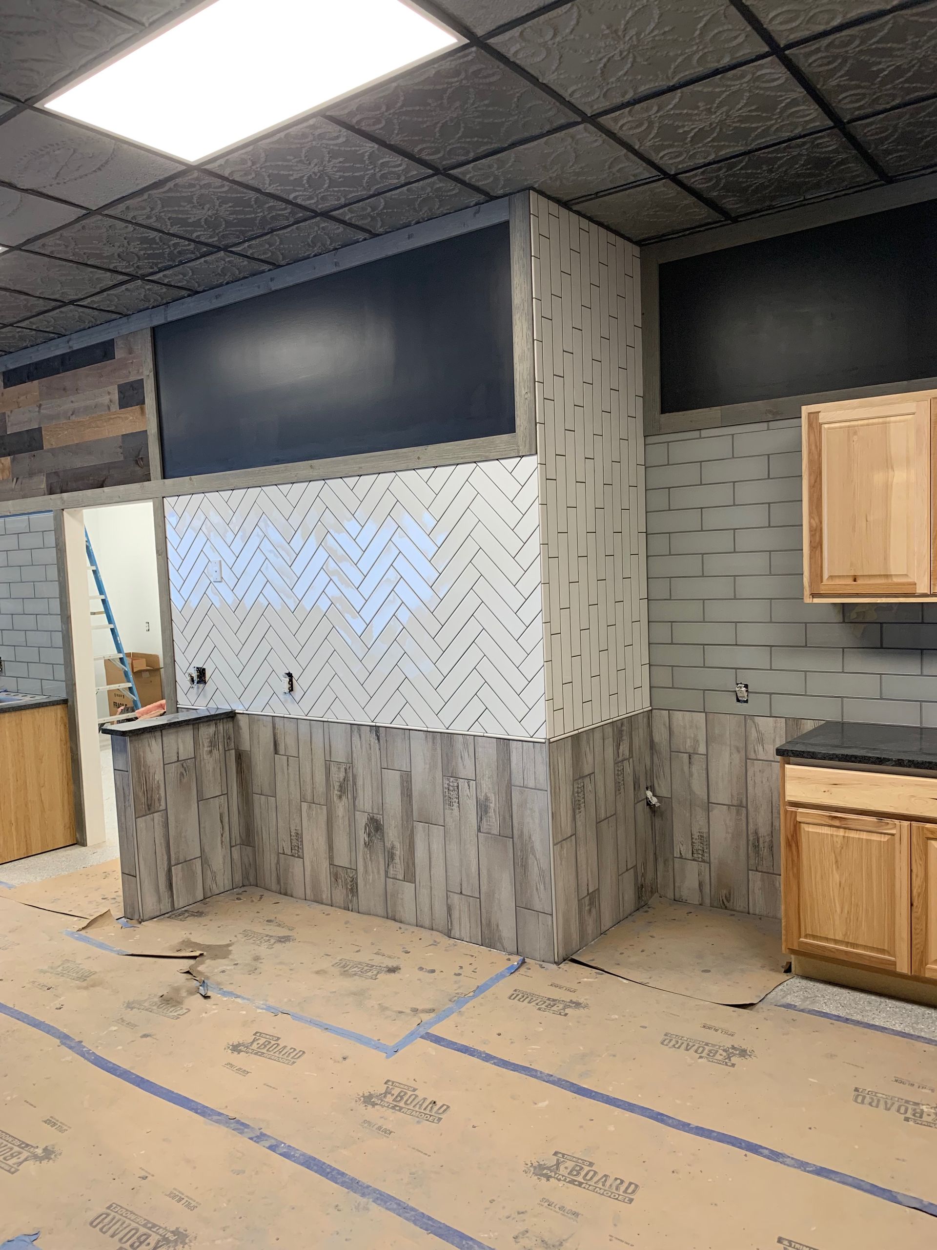 Interior construction, a room with various wall materials and cabinets being installed.