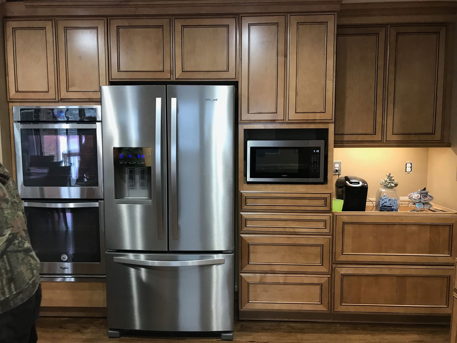 Kitchen with stainless steel appliances, light brown cabinets, and a microwave and oven.