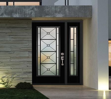 Modern front door with frosted glass panels beside a stone exterior wall at dusk