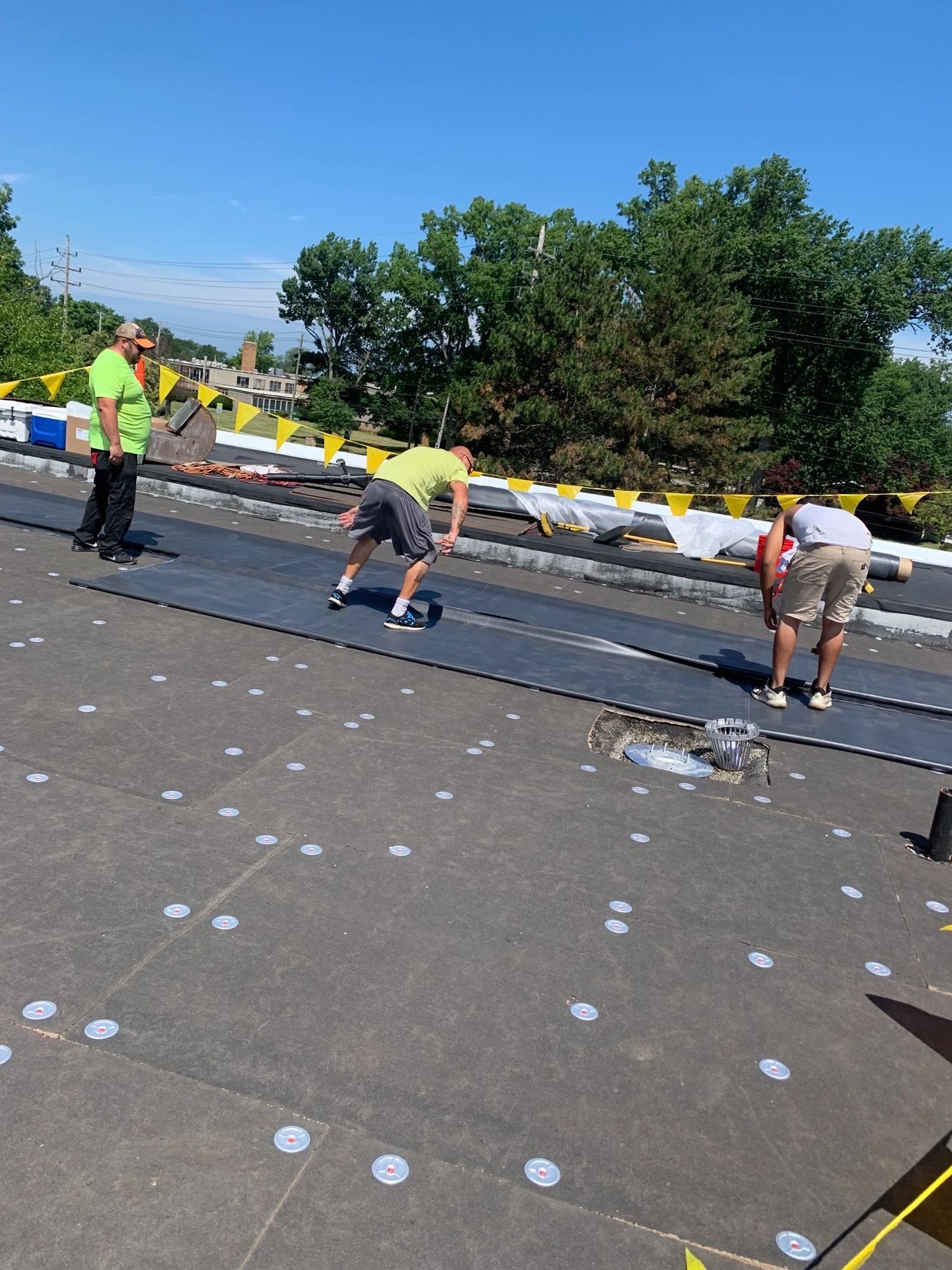 A group of men are working on a roof.