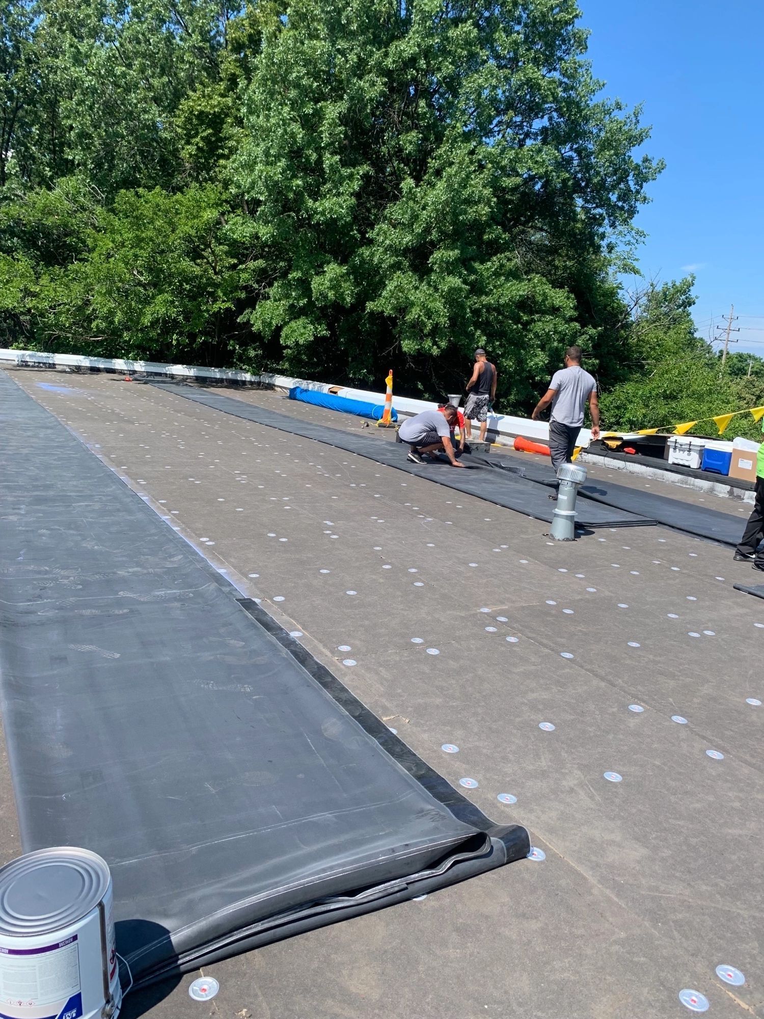 A group of people are working on a roof.