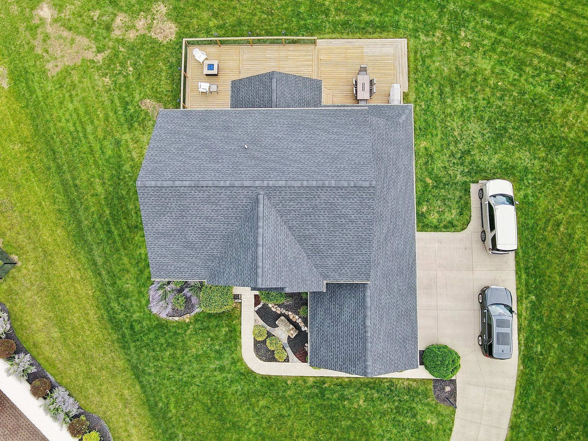 An aerial view of a house with a car parked in front of it.