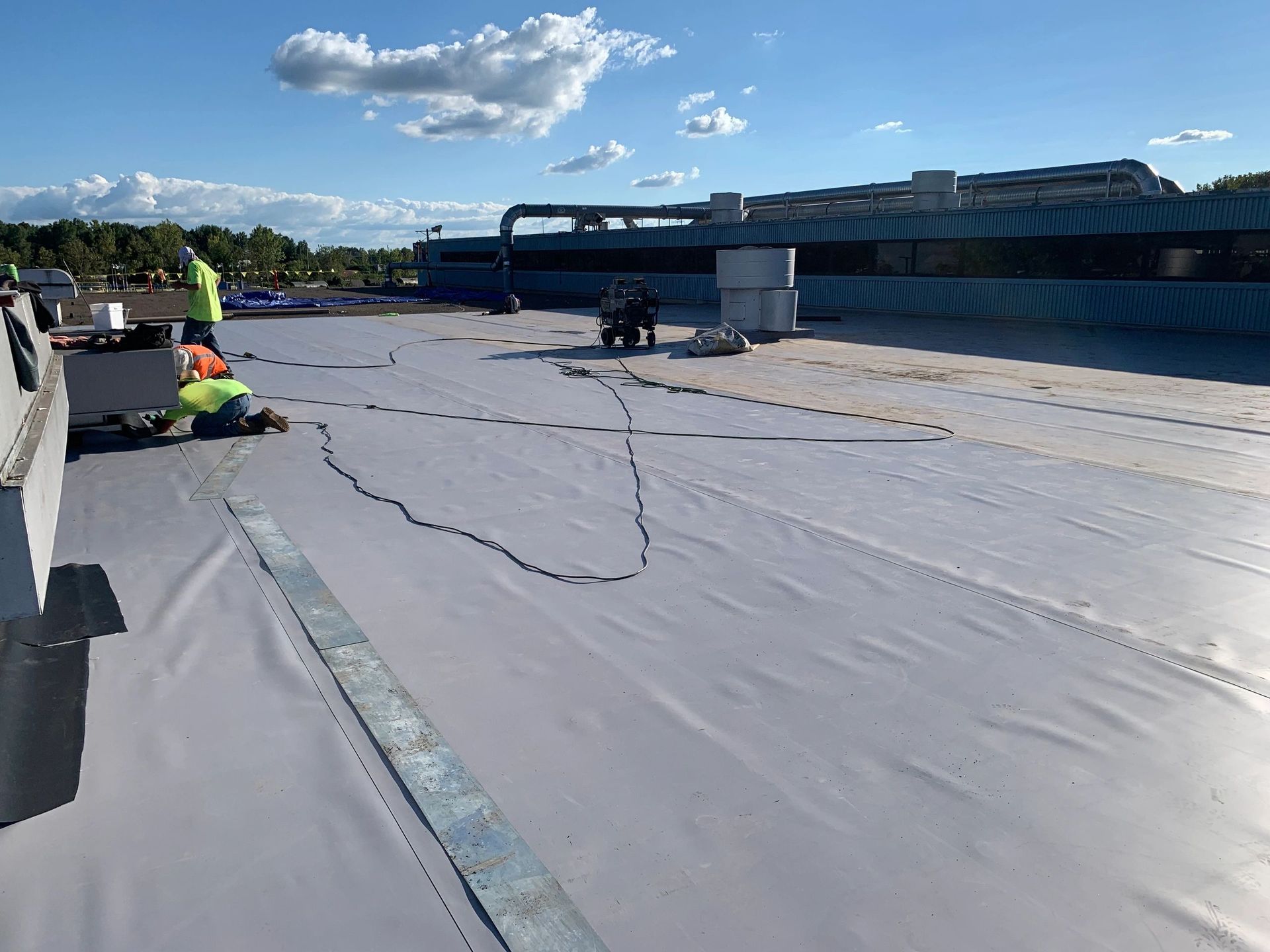 A group of people are working on a roof.