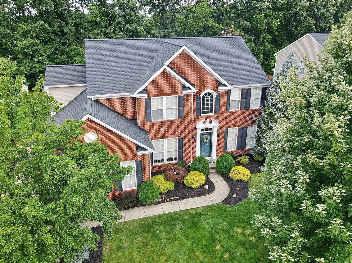 A row of houses with a blue sky in the background.