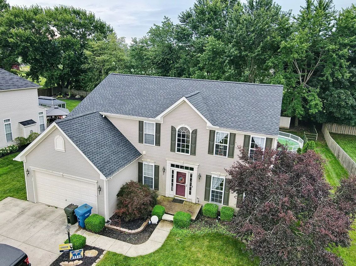 An aerial view of a house with a car parked in front of it.