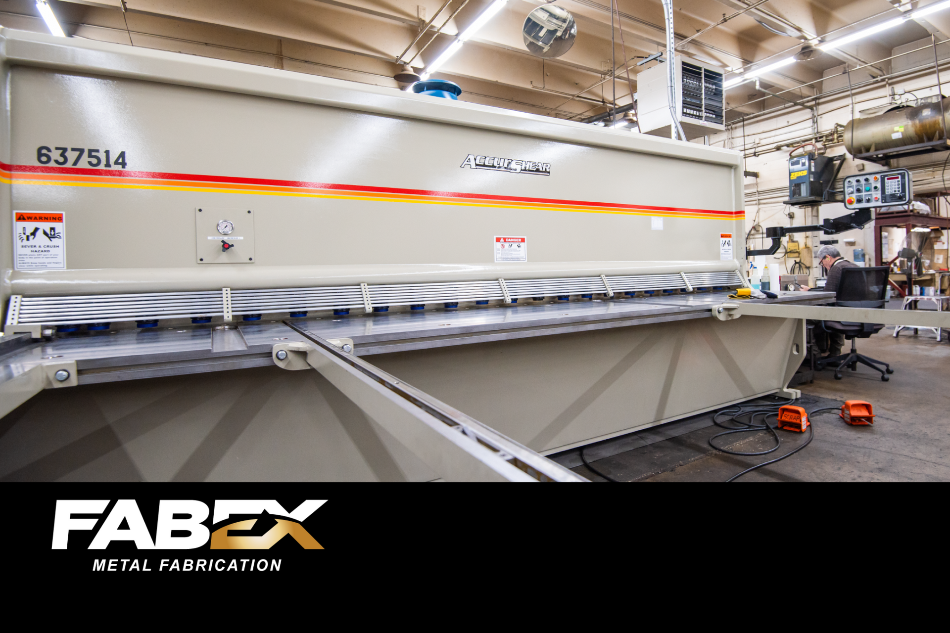 Large industrial machine in a metal fabrication shop with FABEX Retail Fabrication branding.