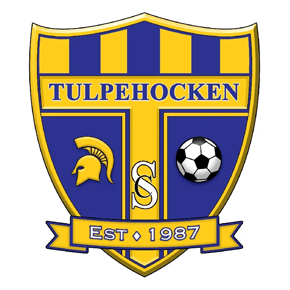 Tulpehocken Soccer Club logo: a blue and gold shield with a Spartan helmet, a soccer ball, and the text 