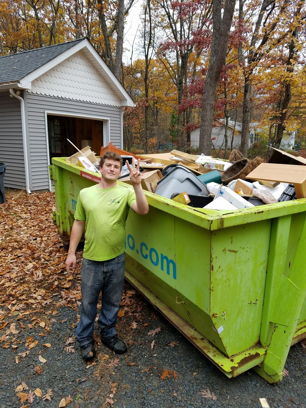 A man in an adr shirt stands in front of a truck