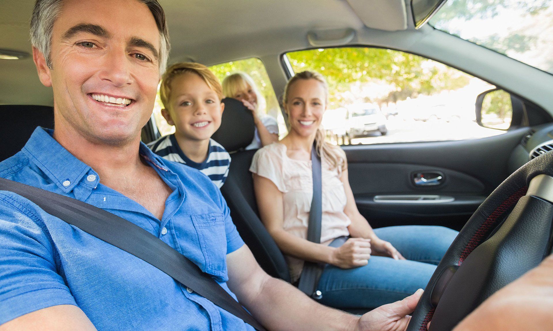 Happy family inside their car