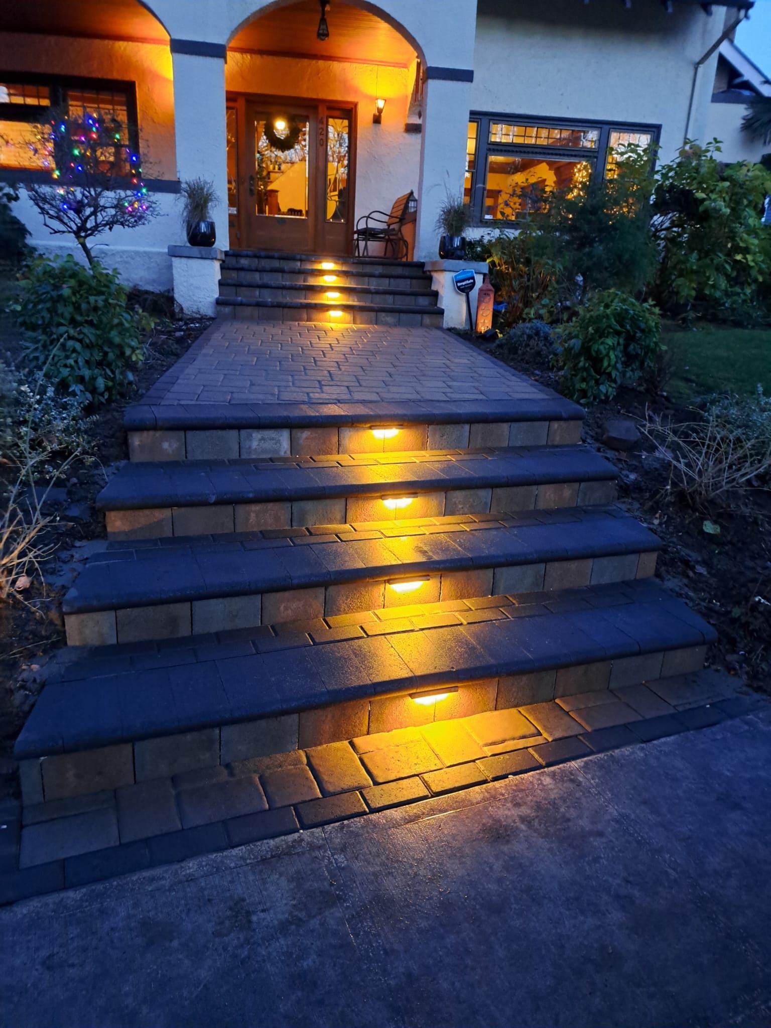the steps of a house are lit up at night