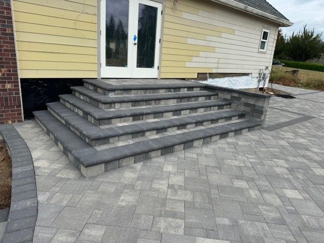 A patio with stairs leading up to a house