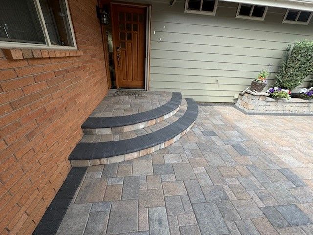 A brick house with steps leading up to the front door